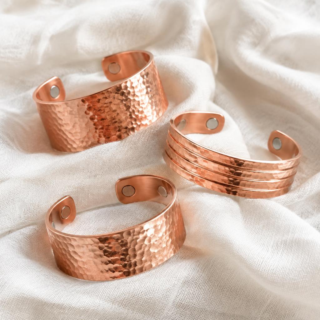 Polished and hammered copper cuffs on linen