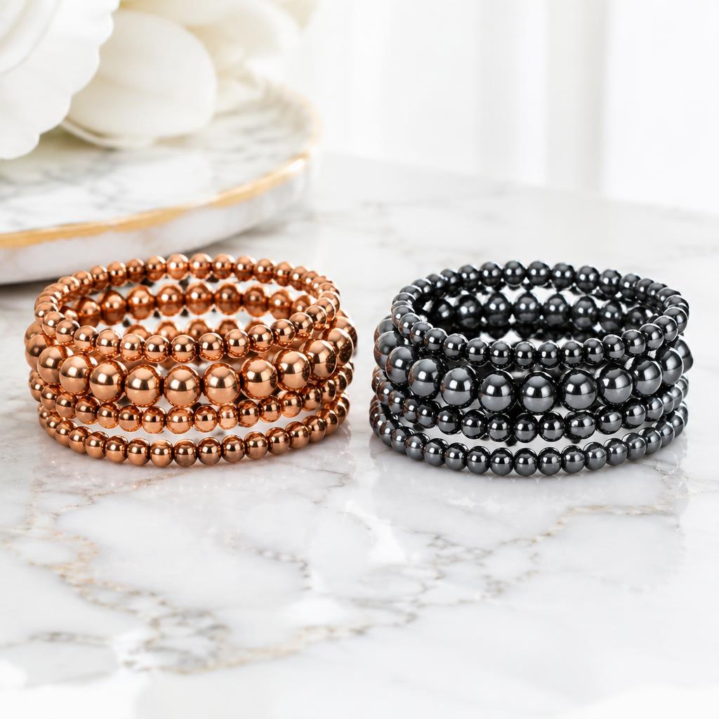 Copper and gunmetal hematite bracelets arranged together